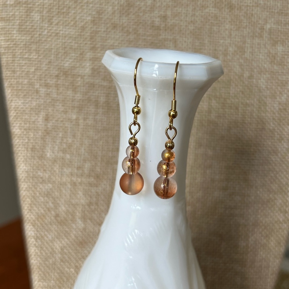 Champagne and gold-tone bead earrings.
